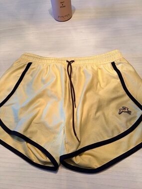 Tracksmith Van Cortlandt Yellow Athletic Shorts with Black Trim